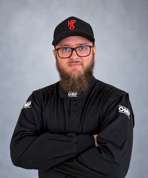 Yuri in his black racing suit and HeuPerformance cap.